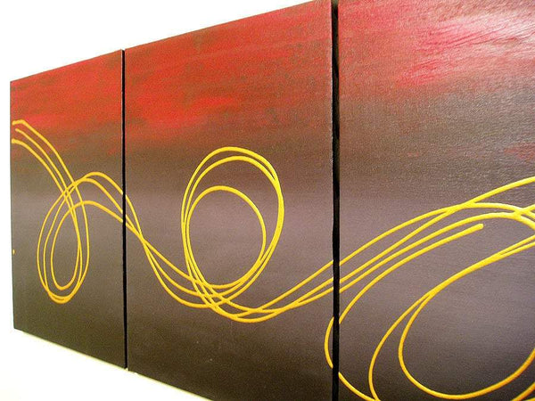 triptych wall art " Gold Horizon " at an angle on living room wall