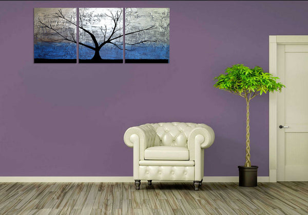 silver paintings of tree on purple wall