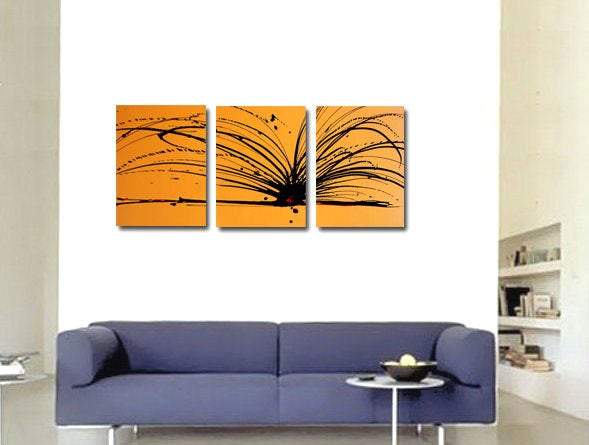 white wall with yellow canvas triptych on it " in golden yellow and black