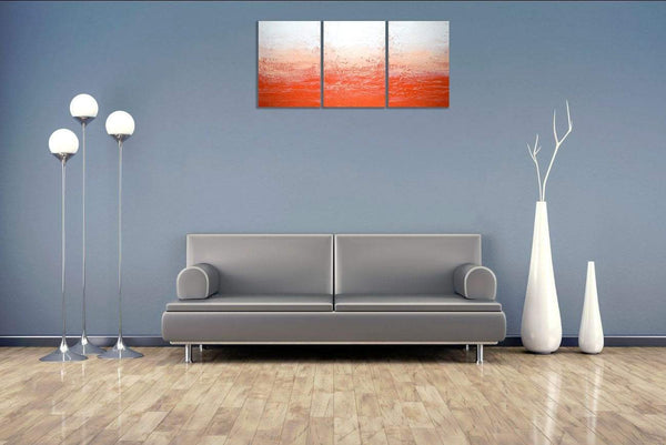 orange painting on grey wall in triptych canvas style