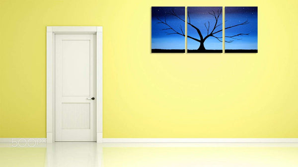 blue tree painting in an abstract style on a yellow wall